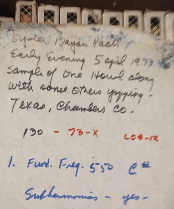 A handwritten label on a reel-to-reel tape box noting a howl recorded in Chambers County, Texas, in 1973, with frequency notes.